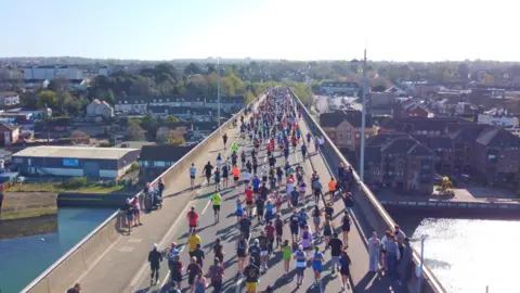 ABP Southampton Marathon Southampton's Itchen Bridge on a sunny day with large numbers of runners taking part in the city's marathon.