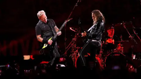 Metallica play on stage during one of their concerts 