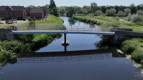 General view of a bridge over the river in Kingsbury Water Park