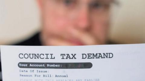 Man looking at a council tax bill
