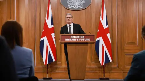 Sir Keir Starmer addressing journalists from a podium in Downing Street