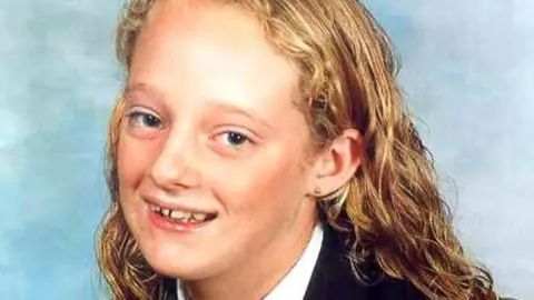 Family handout Danielle Jones smiling in a school photograph. She has long blonde hair and is wearing a dark blazer and white shirt.