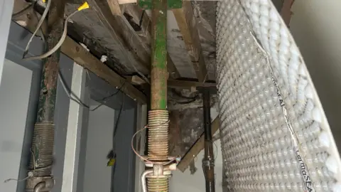 Roof joists holding up a damaged ceiling