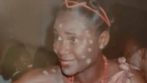 Valerie Lolomari Valerie when she was younger in traditional Nigerian dress and make up, with white paint marks on her face