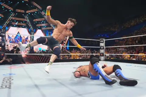 WWE via Getty Images John Cena lands a Five Knuckle Shuffle on AJ Styles during Crown Jewel at RAC Arena on October 11, 2025 in Perth, Australia.