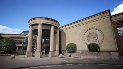 PA Media High Court in Glasgow - a sandstone building with large columns forming a circular entrance 