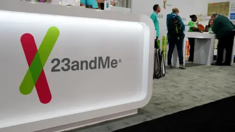 The 23andMe logo at a 2019 genealogy conference where the DNA testing company hosted a booth for attendees
