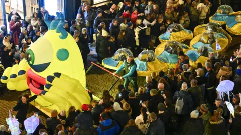 Stuart Walker A parade follows a space themed carnival