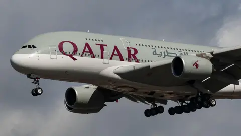 Qatar Airways Airbus A380 double decker plane on approach to landing at Heathrow Airport.