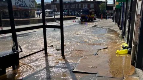 Water flows down Ipswich street.