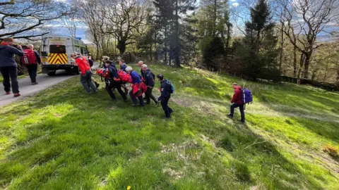 Langdale Ambleside Mountain Rescue Team (LAMRT)  Mountain Rescue teams carrying a casualty to safety