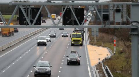 Traffic passes an emergency bay on a smart motorway section. 