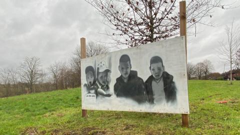 A spray painted picture of the Babbs Mill Boys near the scene of the tragedy