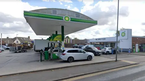 Google A petrol forecourt with cars parked at the pumps and an M&S Simply Food store in the background.