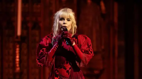 PA Media Paloma Faith is seen performing during the carol service