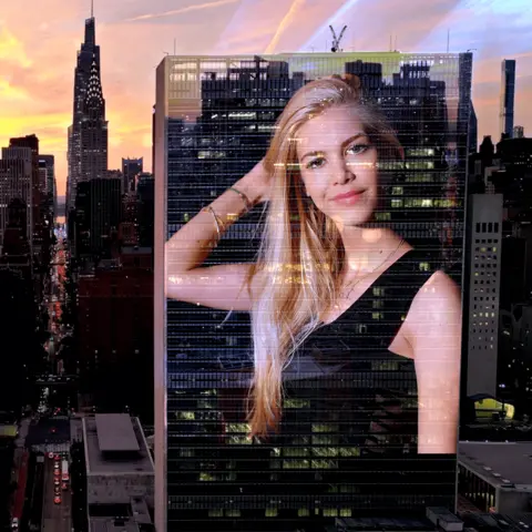 BBC Kat Torres' picture projected onto a stylised backdrop of the New York skyline