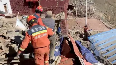 Rescue teams work amidst rubble in the aftermath of the earthquake