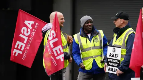 PA Media Train drivers from the Aslef union on the picket line at Euston station