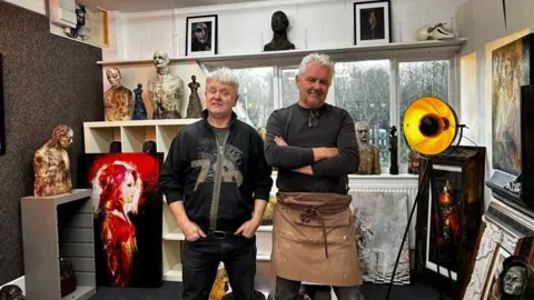 Studio Skellett Paul and Jason Skellett posing with their statues