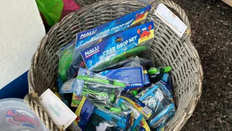 A bucket of crabbing nets in a wicker basket