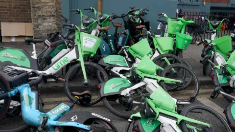 PA Media Discarded Lime and Forest e-bikes in London.