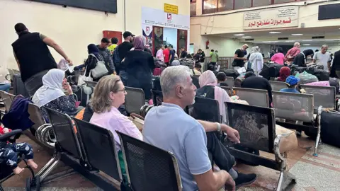 REX/Shutterstock Foreign nationals exiting Gaza at Rafah crossing