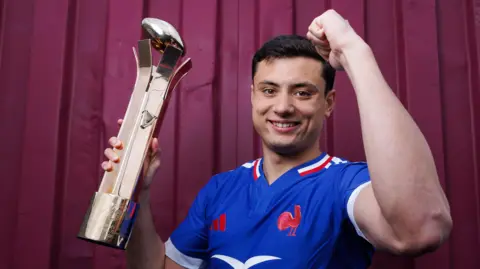 Louis Bielle-Biarrey with the player of the championship trophy