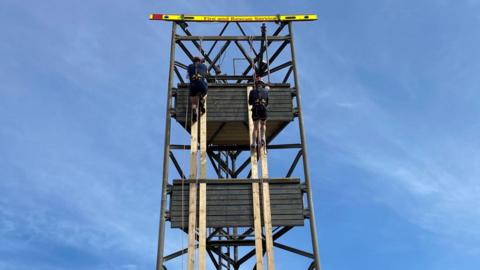 Firefighters at the top of the tower
