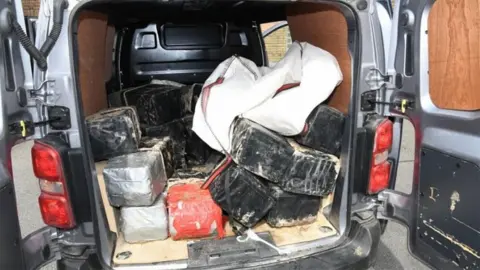 National Crime Agency Police photograph of the drugs in large tape blocks piled up in the back of a grey van