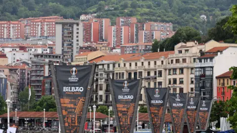 Reuters Europa League final signage is seen in Bilbao with the backdrop of flats and trees