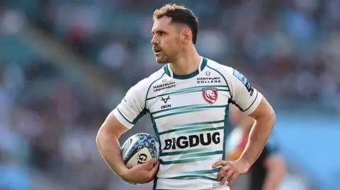 Tomos Williams with a ball under his arm while playing for Gloucester