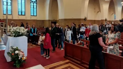 People queue to venerate the relic of Blessed Carlo Acutis