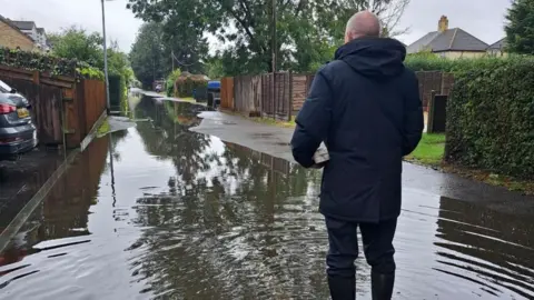 Karen Millward Rear of man standing in flood