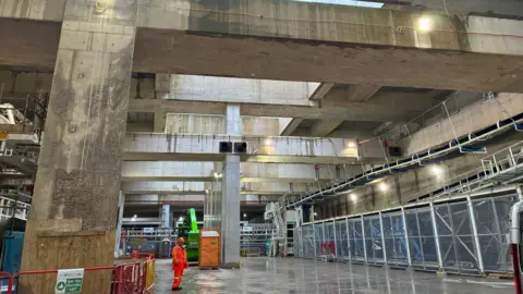 Katy Austin A large open underground space made of concrete.