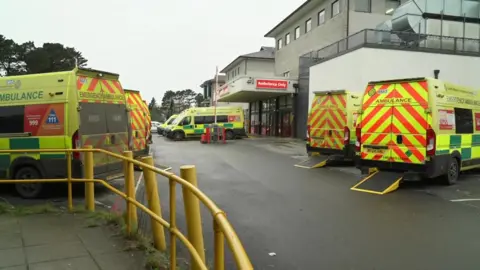 Six ambulances parked outside Royal Cornwall Hospital's emergency department 