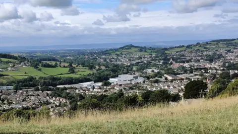 BBC A view looking over Stroud from high, with small housing, taken from Selsey Common