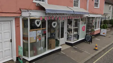 Google Maps A Google Maps streetview image of the front of Bildeston Village Stores and Post Office. 
