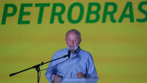 EPA President of Brazil, Luiz Inacio Lula da Silva, speaks in front of a green and yellow Petrobras sign