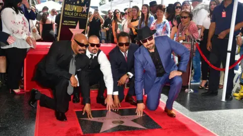 Getty Images Cypress Hill members Sen Dog (L), DJ Muggs (2-L), Eric Bobo and B-Real (R) pose at their just unveiled Hollywood Walk of Fame Star during a ceremony in Hollywood, California on April 18, 2019