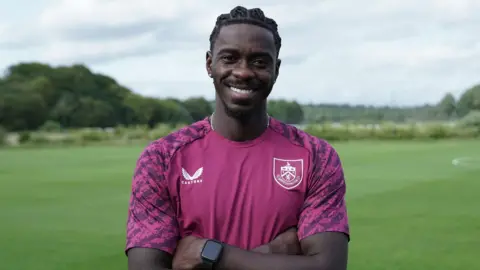 Axel Tuanzebe poses for a photo in Burnley kit