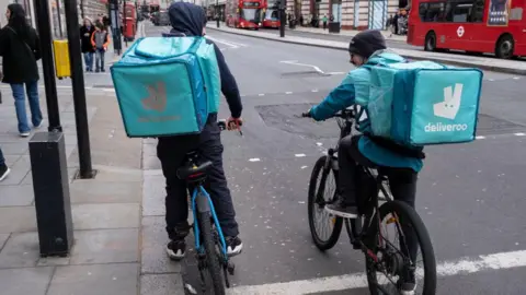 Getty Images Two Deliveroo riders on bikes in central London