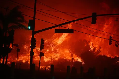 Getty Images Flames overtake an intersection of the Palisades Fire on 7 January 2025