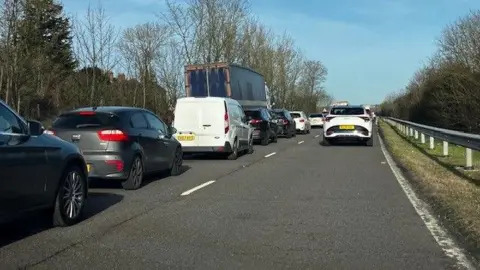 An image of the road with lots of cars