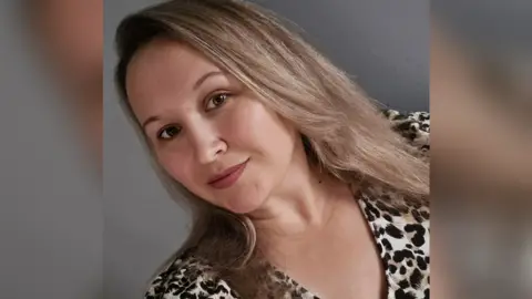 Women with long hair smiling at the camera in a selfie mode.