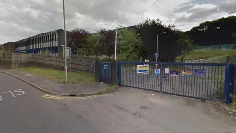 Google Hemel Hempstead Gasworks on London Road standing empty, shortly before demolition took place in 2017. The gates are locked and the land surrounding the building looks overgrown