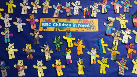 A display board full of Pudsey Bears. Each bear has been coloured and decorated. There is a sign on the board reading "BBC Children in Need"