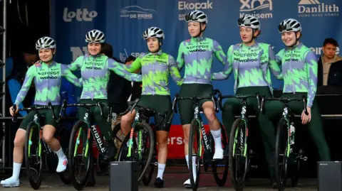 Getty Images Six cyclists on stage with their bikes