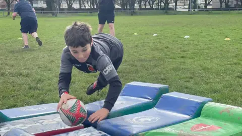 Family photo Theo playing rugby