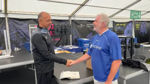 John Fairhall/BBC Jason Dozzell (left) pictured with one of the walking football participants 