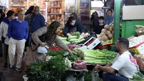 EPA Iranians shop in a bazaar in Tehran, Iran (24 March 2026)